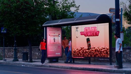 AXE · giant claw-machine bus stop